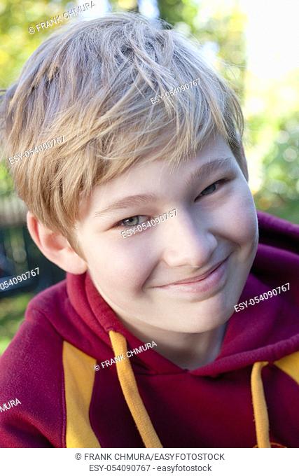Portrait of a Boy with Blond Hair Outdoors