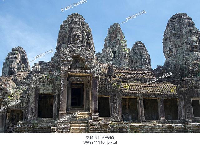 Low angle view of ornate carvings on Prasat Bayon temple, Angkor, Siem Reap, Cambodia
