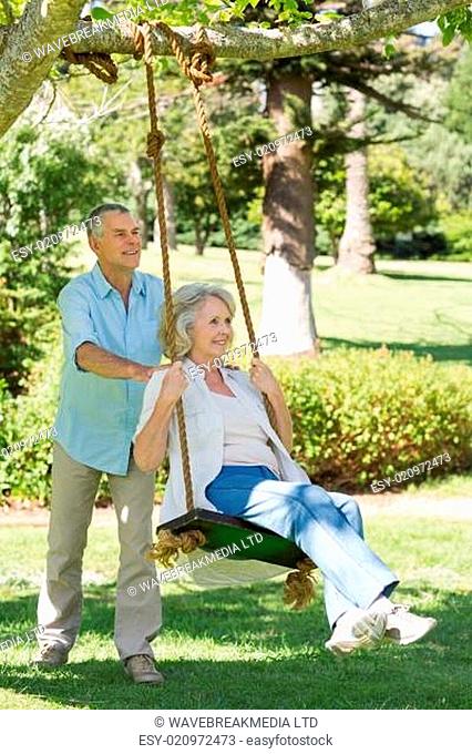Mature couple at swing in park