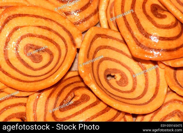 Closeup view with selective focus of a large number of round cookies with coconut filling lines