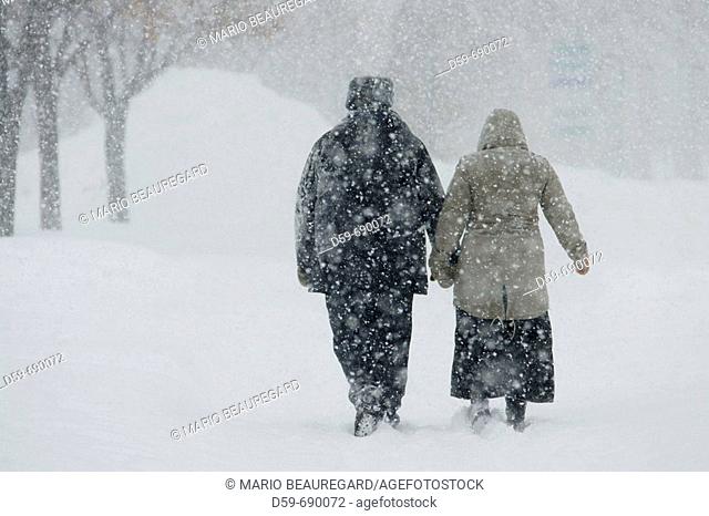 Couple walking during snowstorm