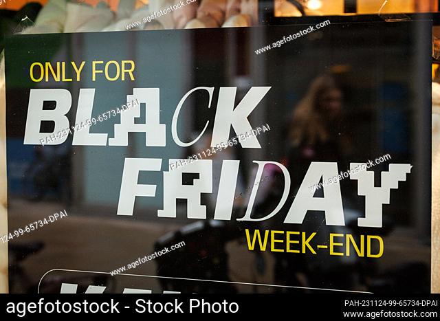 24 November 2023, Lower Saxony, Osnabrück: ""Black Friday"" can be read on a poster in a shop window. Numerous stores and online stores celebrate Black Friday...