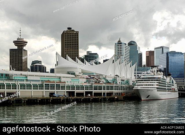 Cruise ship at the Vancouver Trade and Convention Centre with Harbour Centre and high rises downtown Vancouver, British Columbia, Canada