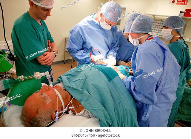 Student doctor observing Surgeon performing Hernia operation in the Day Surgery Unit