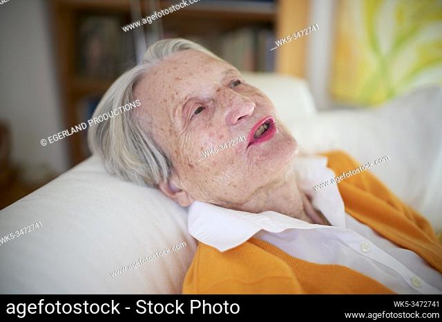 Senior woman relaxing at sofa