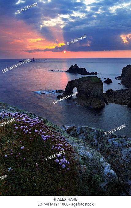 England, Cornwall, Land's End. A view of Land's End the most westerly point in England at sunset with Longships Lighthouse in the distance
