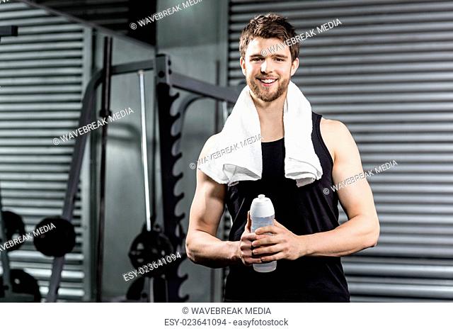 Fit man holding water bottle
