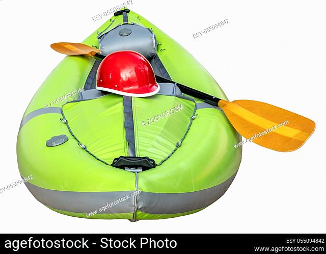 green inflatable whitewater one person kayak with a paddle and helmet isolated on white