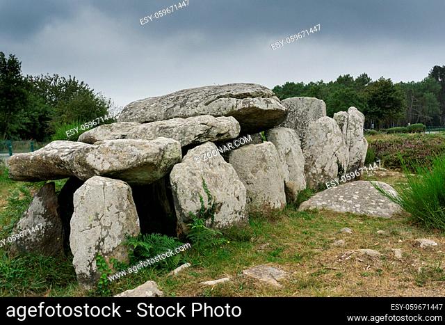 view of prehistoric monolith stone tomb or dolmen in Brittany at Carnac