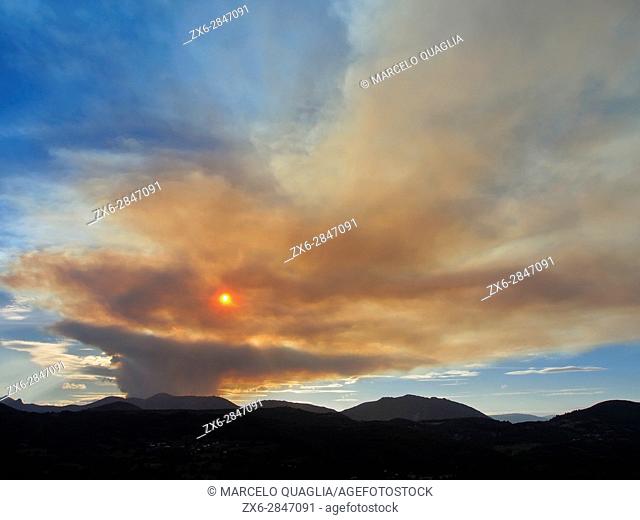 Forest fire cloud at Tieno region, seen from Villandás village at Grado Council, end of July 2015, produced by climate change alterations in temperature and...