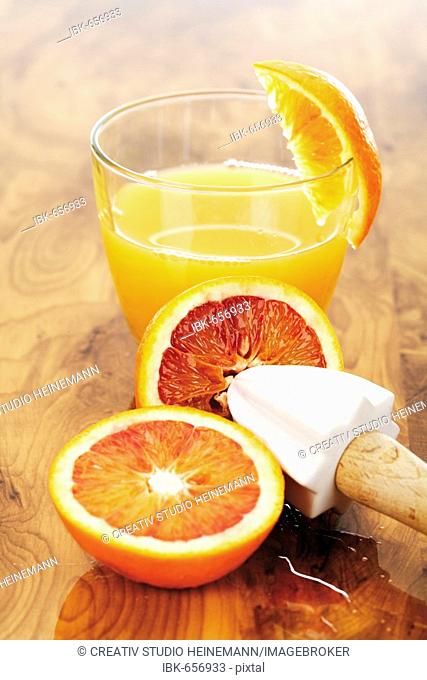 Blood oranges and a glass of orange juice