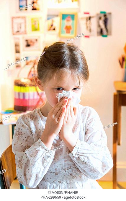 5 year-old girl blowing nose