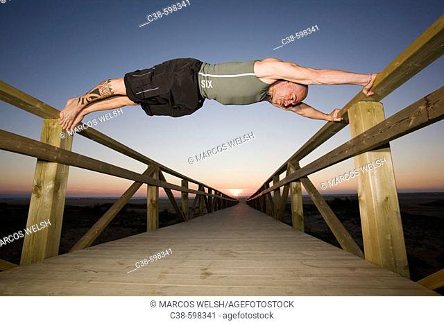 Man Doing Exercise on Footbridge
