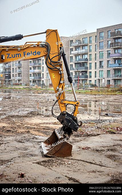 12 December 2023, Hamburg: View of new buildings behind a backer on a construction site in Eidelstedt. The Department for Urban Development and Housing presents...