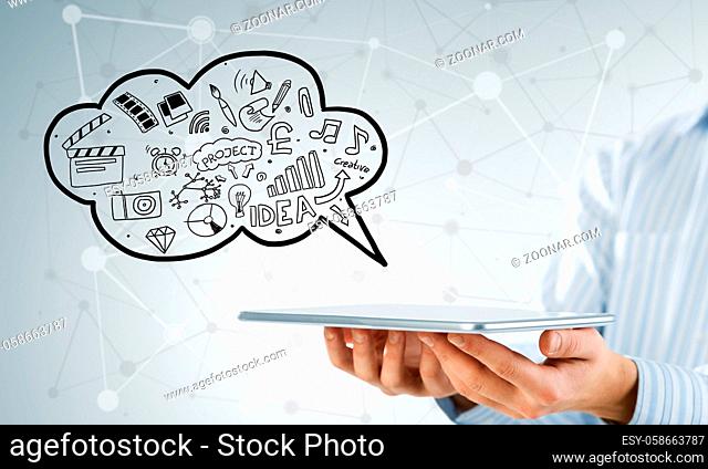 Hand of businessman showing tablet with business sketches in cloud