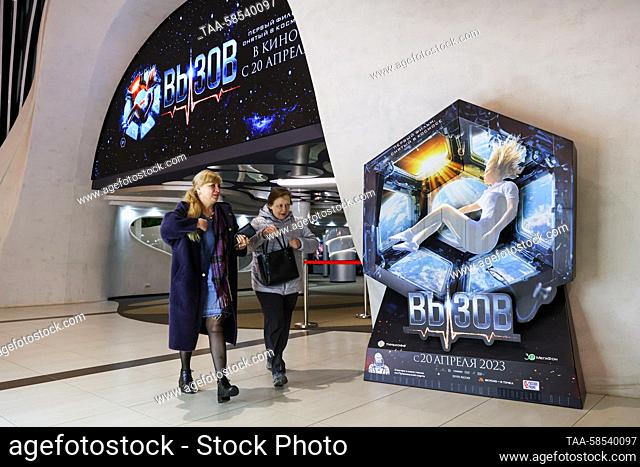 RUSSIA, ROSTOV-ON-DON - APRIL 20, 2023: Women walk past a poster of the 2023 Russian drama film The Challenge, premiering in Russia on April 20