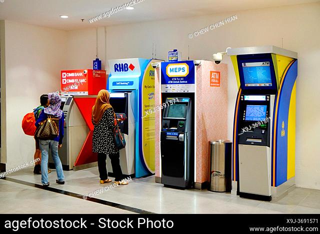 People using ATM cash machines in Kuala Lumpur, Malaysia