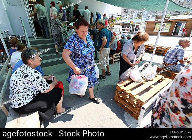 RUSSIA, NOVAYA KAKHOVKA - AUGUST 1, 2023: People are seen outside a humanitarian center. Employees of the center compile food kits and distribute humanitarian...