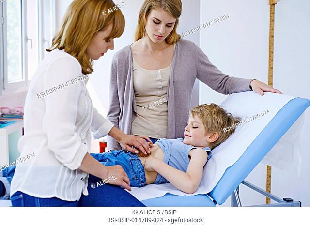 Doctor examining a child's abdomen