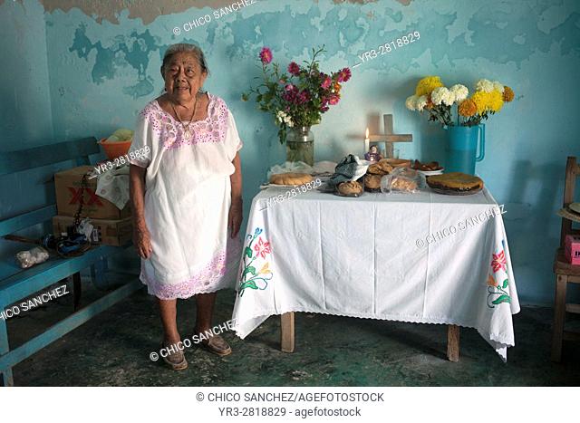 A woman poses by an altar displayed in the Mayan village of Pomuch, Hecelchakan, Campeche, Yucatán península, October 30, 2016