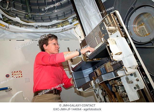 NASA astronaut Peggy Whitson removes the Multi-Purpose Experiment Platform (MPEP) from inside the Kibo airlock aboard the International Space Station