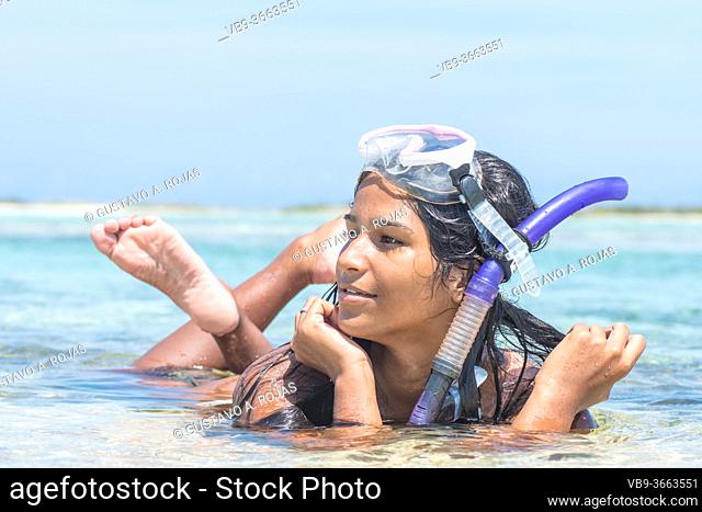 Beach vacation snorkel Brunette woman snorkeling with mask and barefoot. Bikini woman relaxing on summer tropical getaway doing snorkeling activity with snorkel...