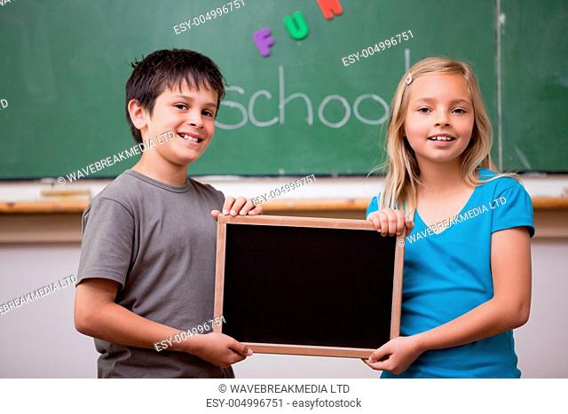 Pupils holding a school slate