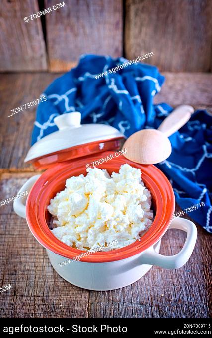 fresh cottage cheese in bowl and on a table