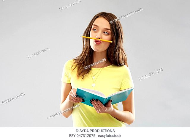 teenage student girl with notebook and pencil