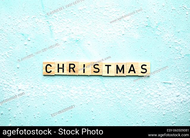Christmas text design background. Wooden sign in snow written text top view, Holiday, merry Christmas concept background copy space