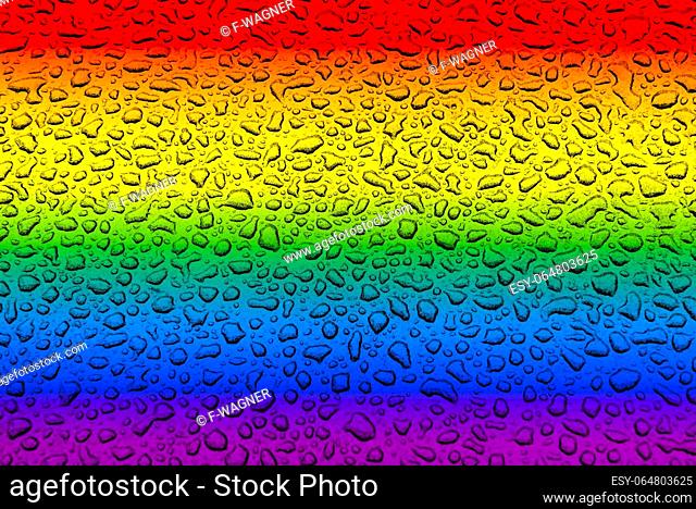Drops of green water in front of a blurred gay and lesbian flag