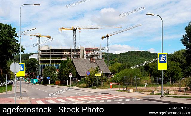 VILNIUS, LITHUANIA - JULY 06, 2018: Construction of a new skyscraper in the capital area of private old houses. Nearby Konstitution Avenue and Business City