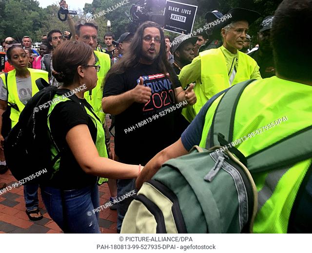 12 August 2018, USA, District of Columbia, Washington: During a demonstration against an extreme right-wing march in front of the White House on the anniversary...