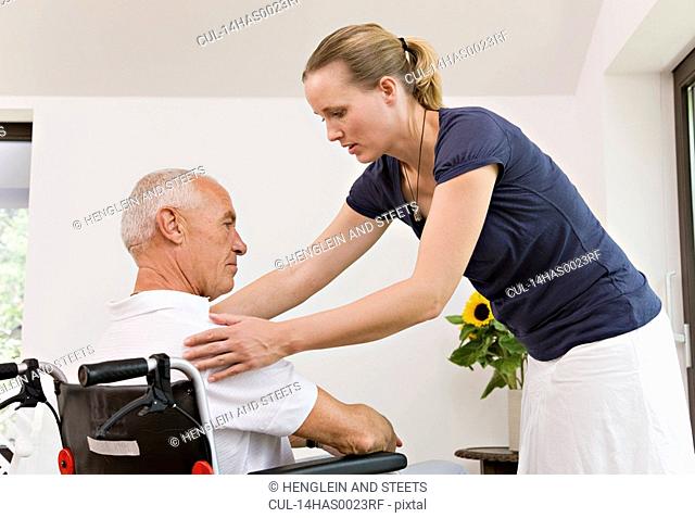 woman helping senior man