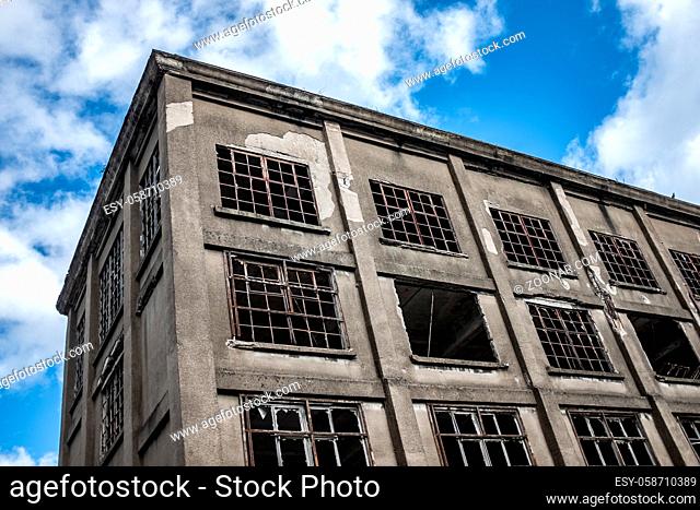 Recession Image Of A Derelict Factory Against A Blue Sky