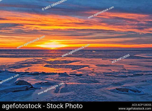 Ice at sunset on frozen Lake Winnipeg Balsam Bay Manitoba Canada