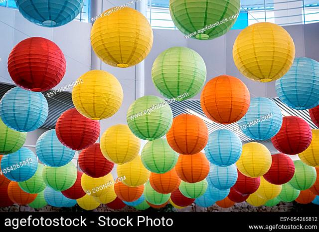The ceiling of the building is decorated with lots of lights in the form of colorful balloons