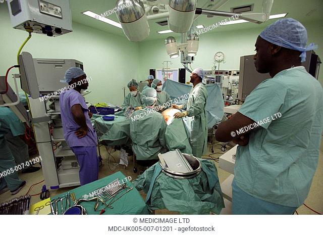Theatre staff prepare a patient for a Laparoscopic Sacrocolpopexy. A Sacrocolpopexy is an operation to treat prolapse of the vaginal wall and restore the...