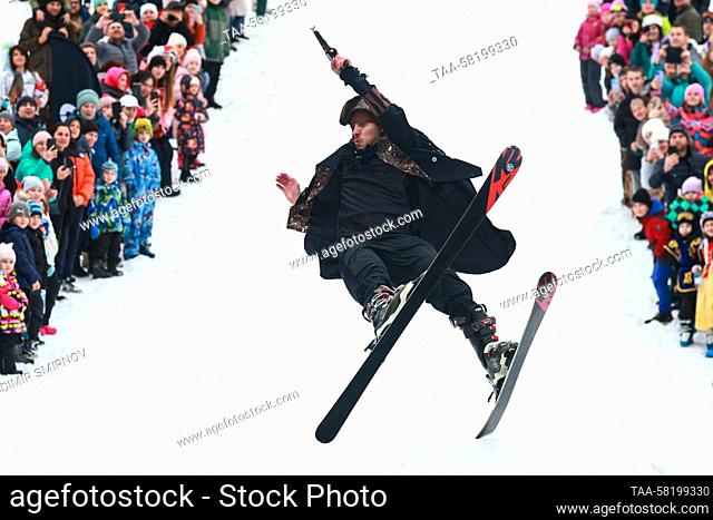 RUSSIA, IVANOVO REGION - APRIL 2, 2023: A dressed-up skier performs a jump during the 2023 edition of Easy-Freezy Festival at Milovka ski resort in the town of...
