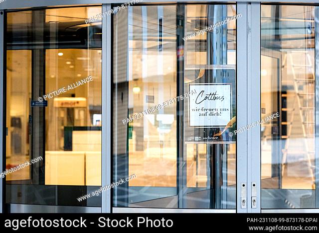 08 November 2023, Brandenburg, Cottbus: An image sign hangs in an entrance to the fashion store ""Aachener"", which has not yet opened