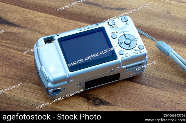 Old digital camera isolated, obsolete and not in use anymore, dusty and dirty