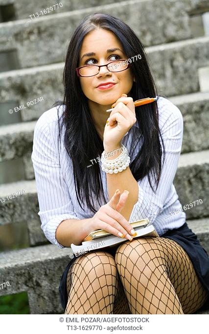 High school young woman with books on her lap
