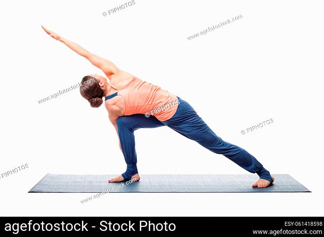 Young fit woman doing Ashtanga Vinyasa Yoga asana Parivritta parsvakonasana - revolved side angle pose isolated on white
