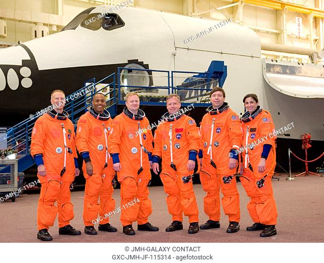 Attired in training versions of their shuttle launch and entry suits, the STS-133 crew members take a brief break for a portrait in the Space Vehicle Mock-up...