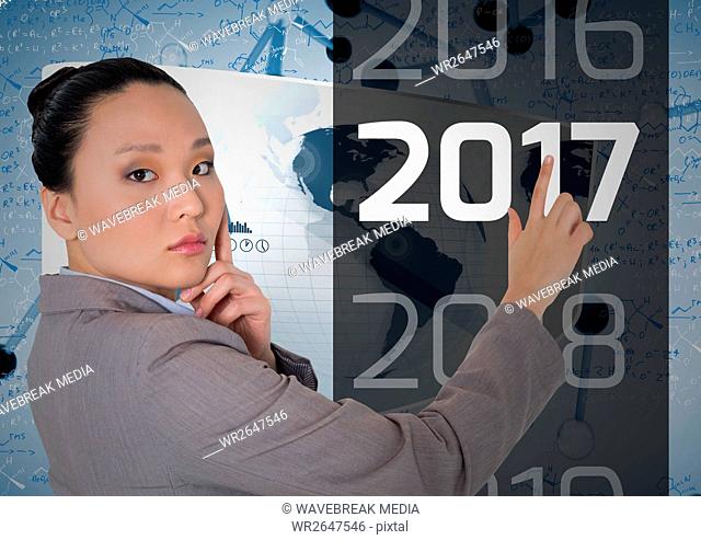 Thoughtful business woman touching 2017 message in 3D digitally generated background