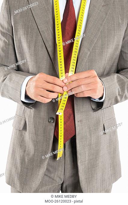 Man wearing a tape measure across his suit