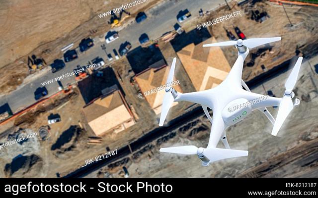 Unmanned aircraft system (UAV) quadcopter drone in the air over construction site