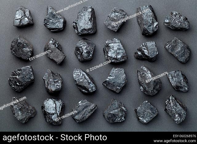 Coal lumps over black background. Top view