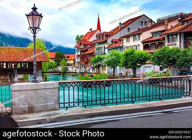 Weir and bridge on Aare river in Old City of Interlaken, important tourist center in the Bernese Highlands, Switzerland