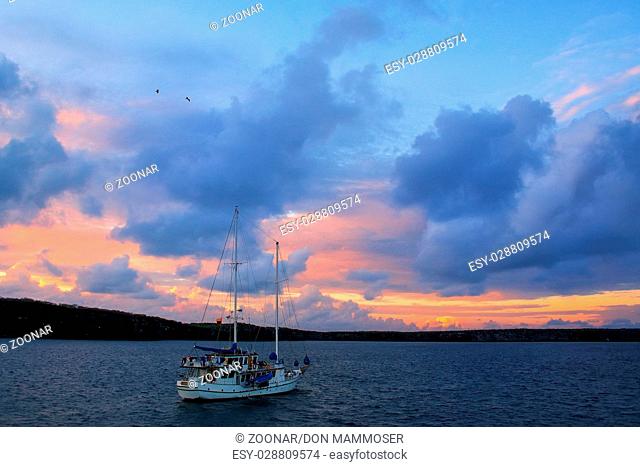 Sailboat in Great Darwin Bay at sunrise, Genovesa Island, Galapagos National Park, Ecuador